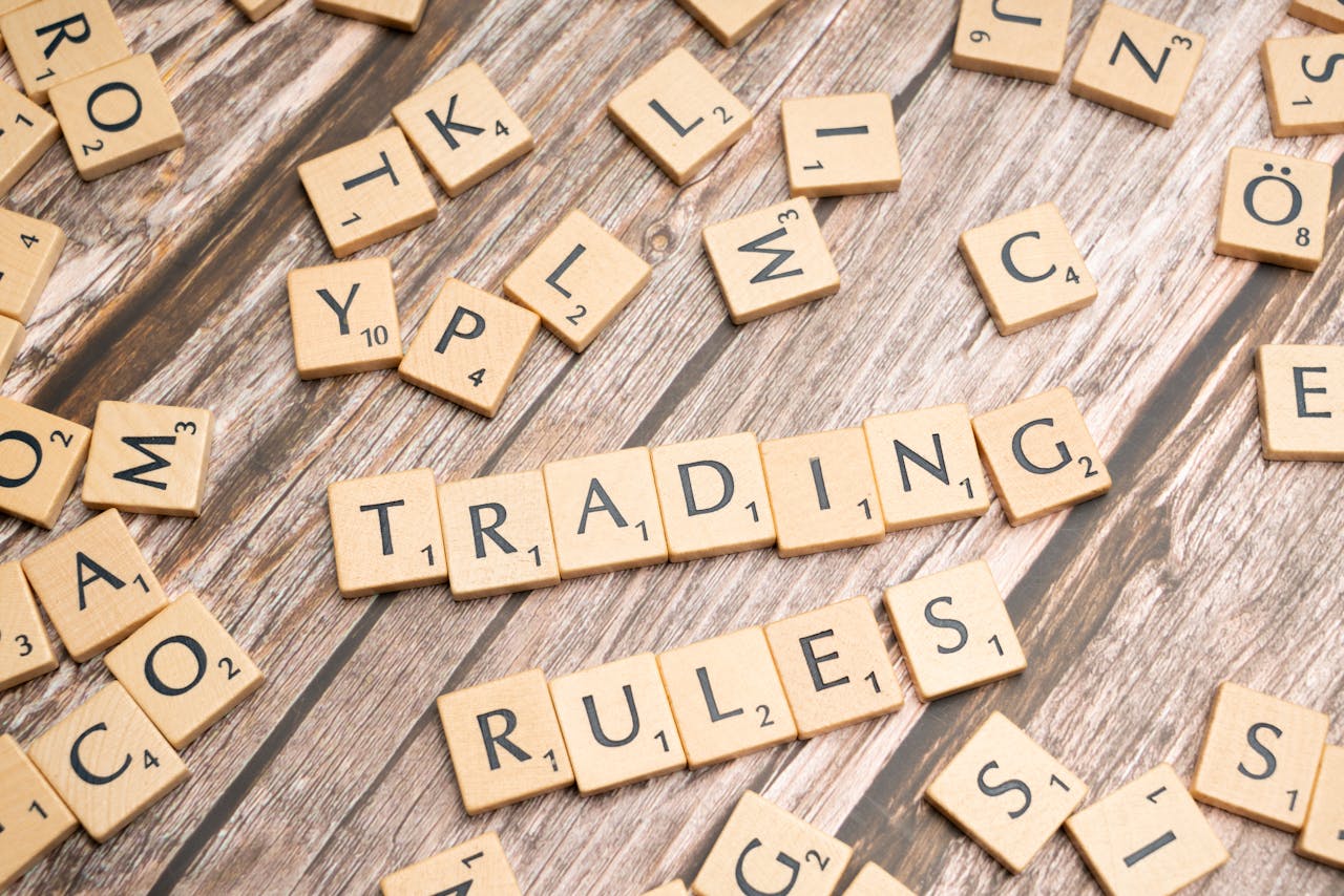 cta-bg Wooden letter tiles arranged to spell Trading Rules on a wooden surface.