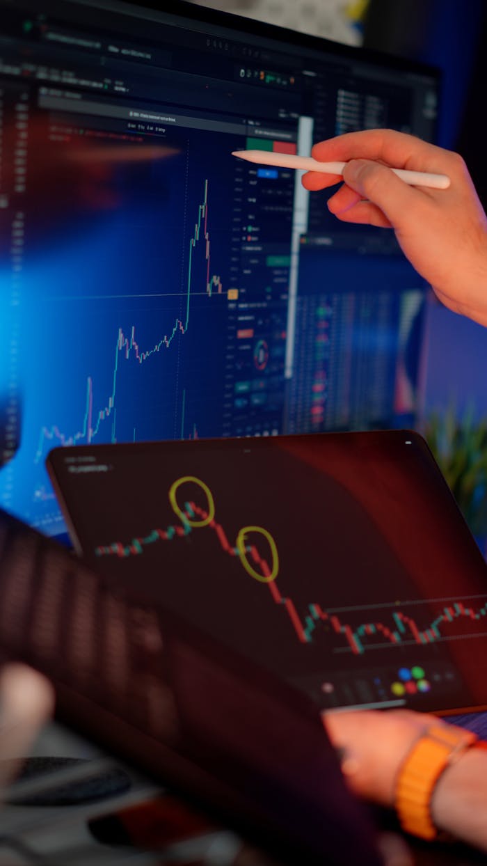 about-01 A person analyzes cryptocurrency market trends on multiple screens with graphs.