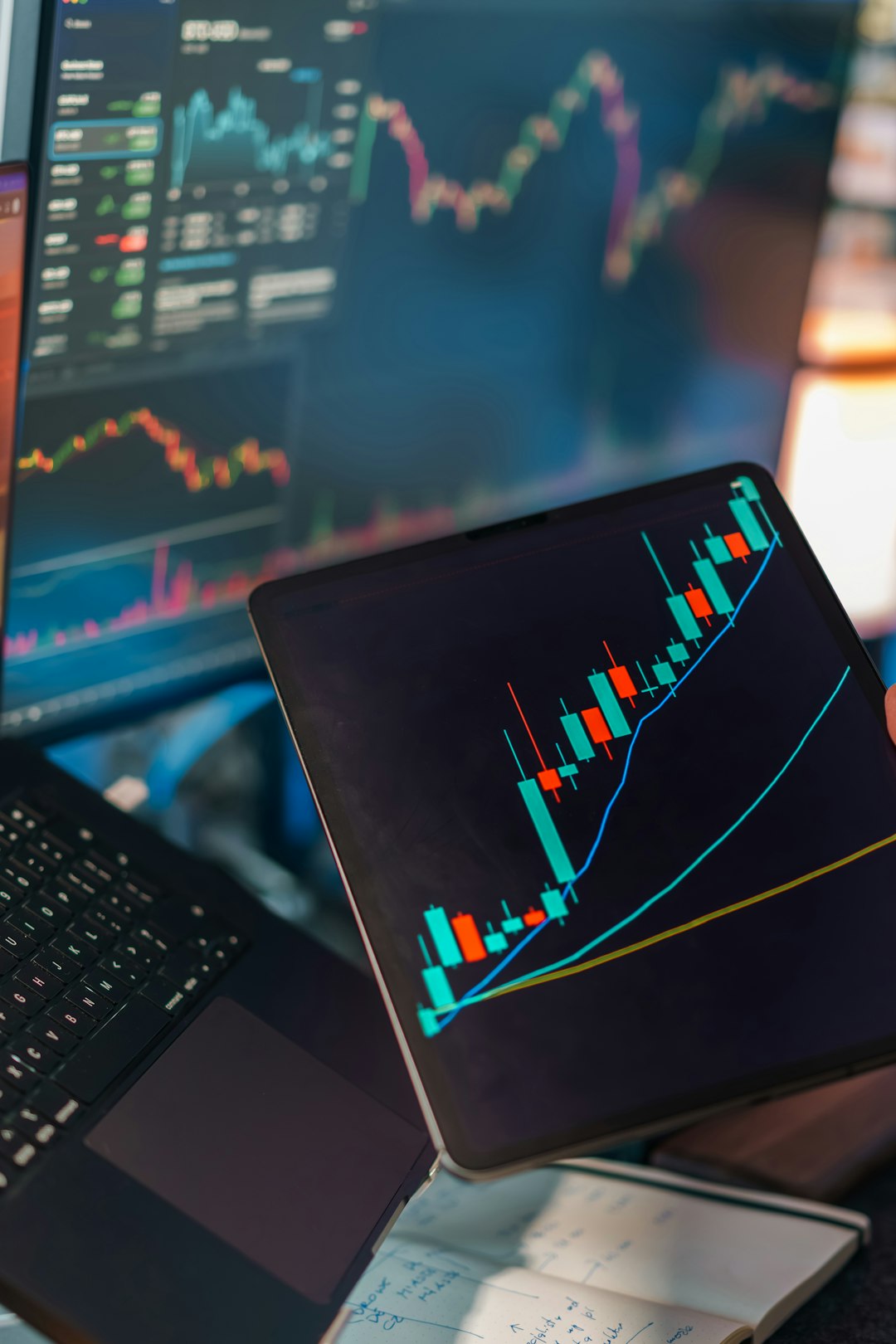 home-services-03 Financial trading analytics candlestick chart laptop tablet. Digital market analysis workspace showing price movement graphs technical indicators data visualization screens investment finance concept editorial business technology